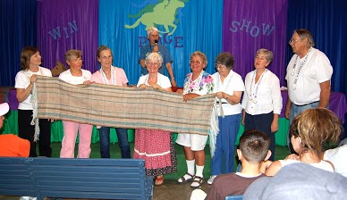 The Glenna Harris Sheep to Shawl Team with their finished product