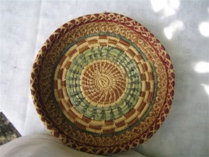 Dyed pine needle and sweetgrass basket by El Adelanto weaver