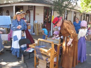 Evelyn Gordon and Sheila Stanger helping kids weave