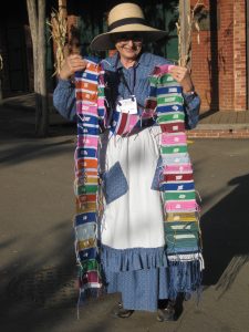 Evelyn Gordon showing bookmarks kids wove, to be cut apart and mailed to them