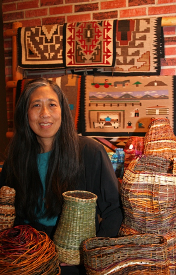 Photo of Donna Sakamoto Crispin, with basketry and weaving work