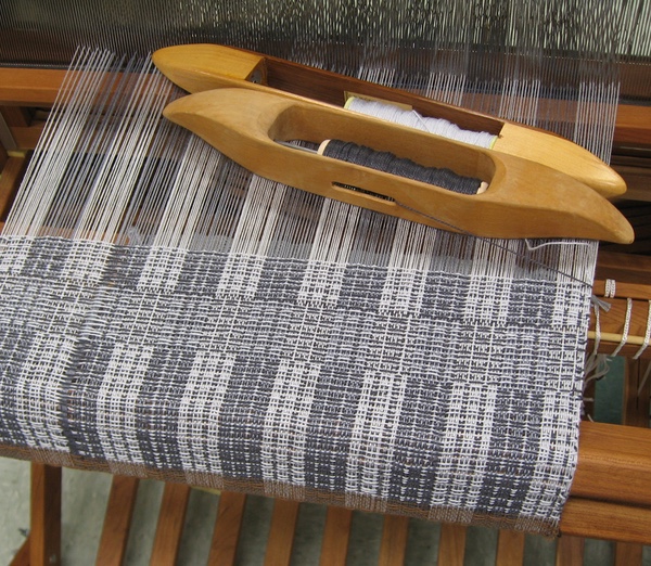 Warp on the loom in a gray and white plaid
