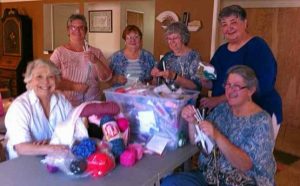 Members assembling 'drinking straw weaving kits' for May Fire at Blue Oak School